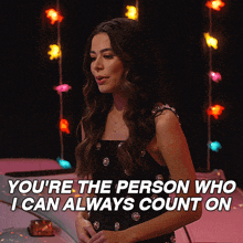 a woman stands in front of a pink car and says " you 're the person who i can always count on