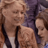 two women are sitting next to each other and smiling