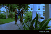 a gif from gifrun.com shows a man carrying another man