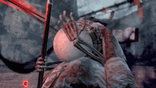 a skeleton is holding a sword in a video game with a red heart in the background