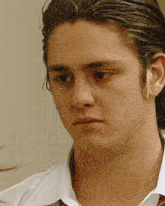 a young man wearing a white shirt and a red tie