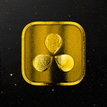 a gold square with three drops of liquid in it