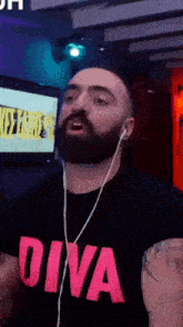 a man with a beard is wearing a diva t-shirt