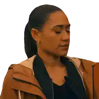 a woman wearing a brown jacket and a black shirt looks down