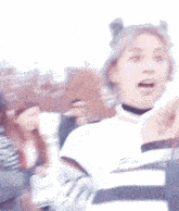 a woman with purple hair is making a funny face while wearing a choker and buns .