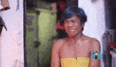 a man with blue hair is wearing a yellow dress and crying