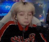 a girl wearing a jacket that says milwaukee is making a face