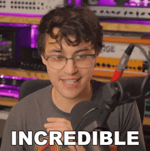 a man in front of a microphone with the word incredible written below him