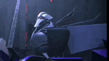 a cartoon robot is sitting in a dark room .