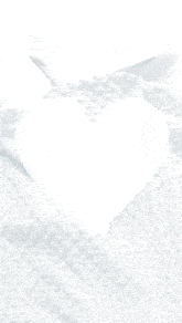 a white heart shaped object is being poured into a white container .