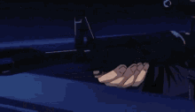 a person is holding a rifle in their hand in a dark room .