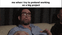 a man wearing glasses is sitting on a couch with a caption that says me when i try to pretend working
