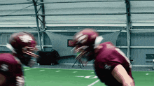 a football player wearing a maroon jersey with the number 8 on the back