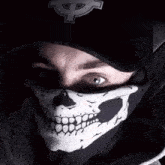 a man wearing a skull mask and a black hat