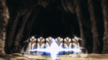 a group of people standing in a dark cave with a light coming out of the middle