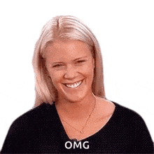 a woman is smiling and wearing a black shirt .