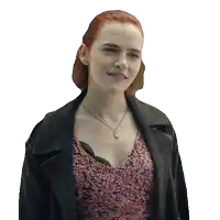 a woman with red hair wearing a necklace and a jacket