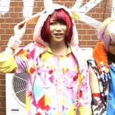 a girl with red hair wears a bunny hooded jacket