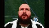 a man with a beard is wearing a striped shirt