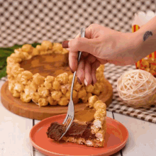 a person is holding a fork over a slice of cake