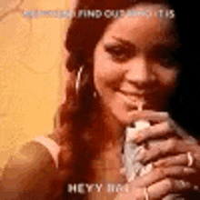 a woman is drinking a drink through a straw while smiling .