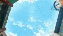 looking up at a blue sky with clouds and buildings