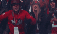 a man wearing a helmet and a red shirt that says moss on it