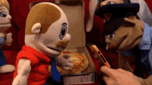 two stuffed animals are looking at a pizza box
