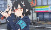 a girl with glasses is holding a gun in front of a building that says ' a ' on it
