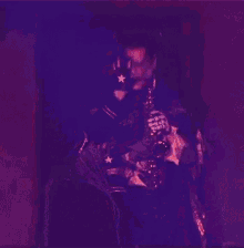 a person is playing a saxophone in a dark room