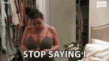 a woman with very large breasts is standing in front of a closet .