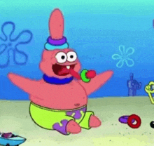 patrick star from spongebob squarepants is sitting on the beach eating a candy bar .