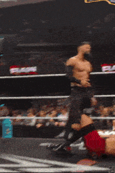 a wrestling match is going on in a ring with a banner that says ea on it