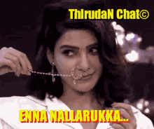a woman is wearing a nose ring with the words enna nallarukk written on it