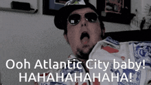 a man wearing sunglasses and a hat says " ooh atlantic city baby ! "