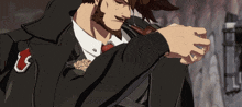 a man in a suit and tie has a red l on his jacket