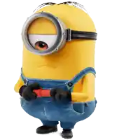 a yellow minion with overalls and goggles holds a red object