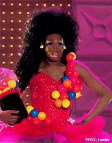 a woman in a red dress with a bunch of colorful balls on it