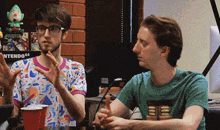 two men are sitting in front of a nintendo 64 sign