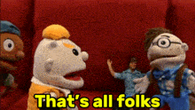 a group of stuffed animals are standing in front of a red wall with the words that 's all folks in yellow letters