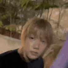 a close up of a person 's face with a blurred background .
