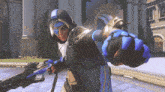 a video game character is holding a gun and pointing at the camera