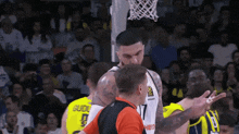 a basketball player wearing a number 17 jersey talks to a referee