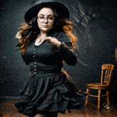 a woman in a witch costume is dancing in a room