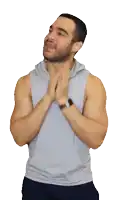 a man with a beard wearing a grey tank top and a watch on his wrist