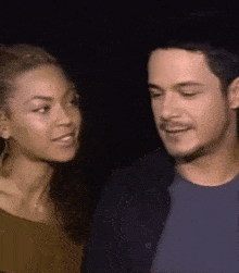 a man and a woman are looking into each other 's eyes