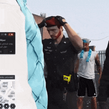 a man with a bandage on his face stands in front of a sign that says 222 on it