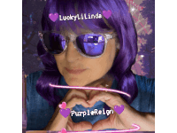 a woman with purple hair and sunglasses makes a heart shape with her hands