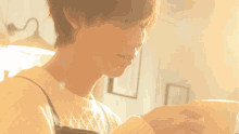 a man in a white sweater is holding a white bowl in his hand