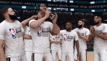 a group of basketball players wearing nba finals shirts celebrate